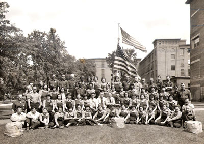 Picture of men and women posing with rope in front of the mills